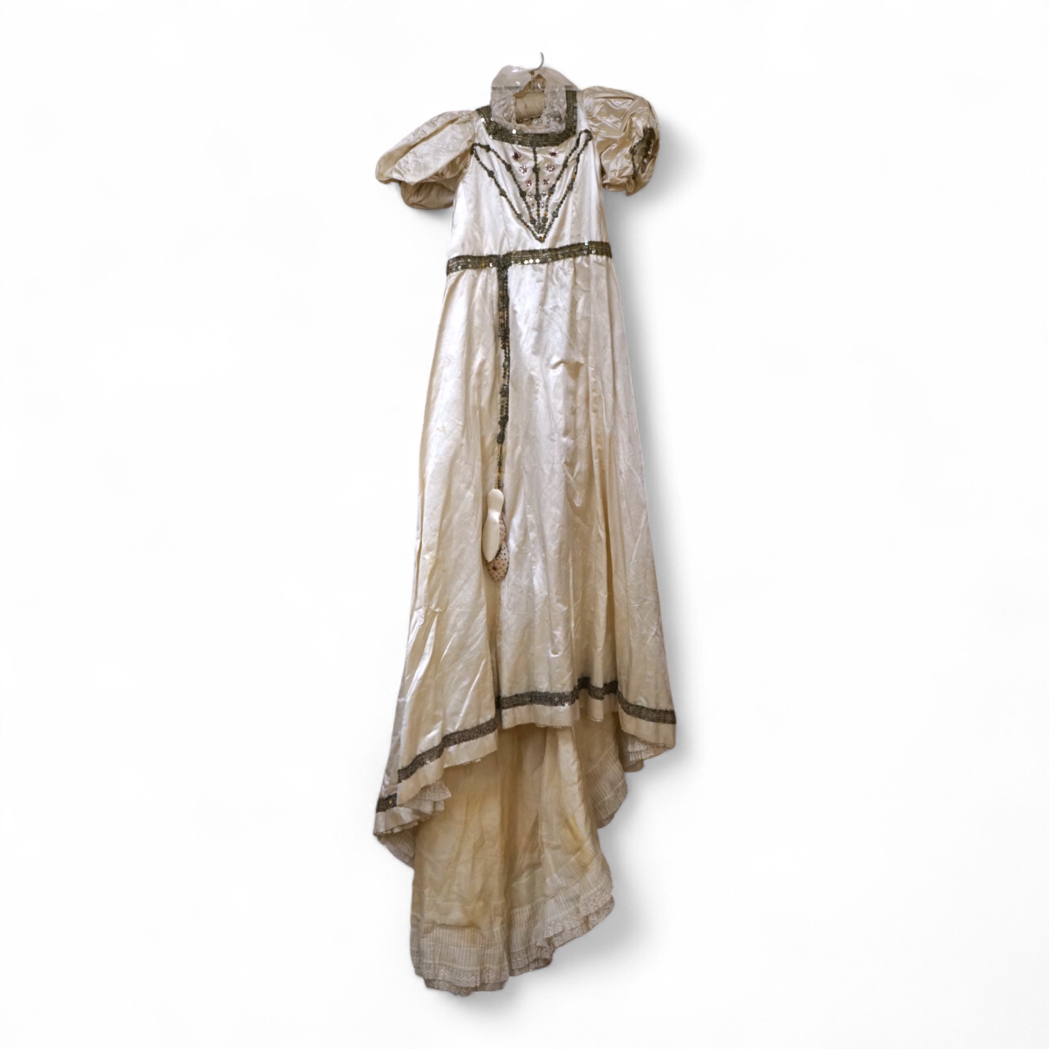 A cream silk satin theatrical costume, mounted with sequined braiding and pair of novelty shoes. Bust measurement 30inches.
